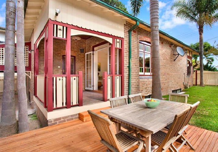 wooden table and chairs on an uncovered patio