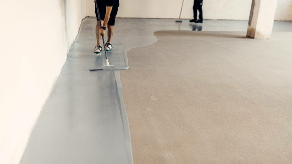 applying epoxy coating on garage floor starting from the sides