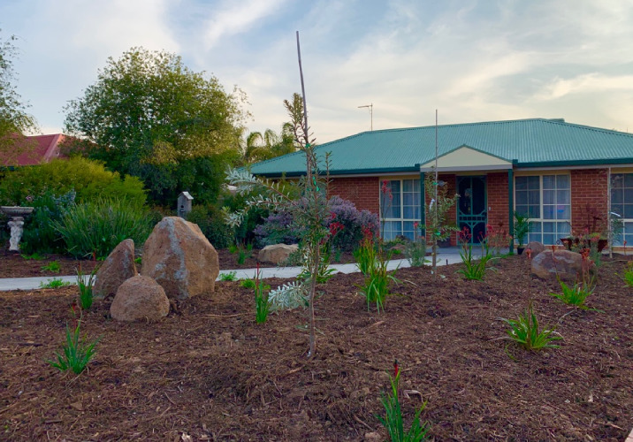 A house with a front yard covered in mulch